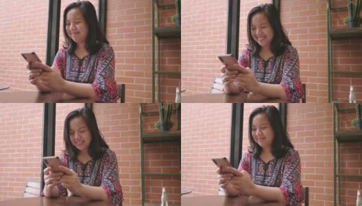 微笑的亚洲女人用智能手机约会应用刷屏高清在线视频素材下载