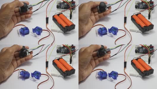 拇指操纵杆模块控制微伺服在一个原型电子电路显示一些测试由一个年轻的发明家在实验室高清在线视频素材下载