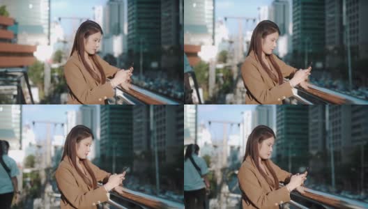 亚洲成功女商人在城市使用智能手机高清在线视频素材下载