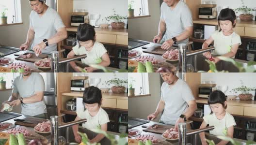 父亲和女儿在厨房一起做午餐高清在线视频素材下载