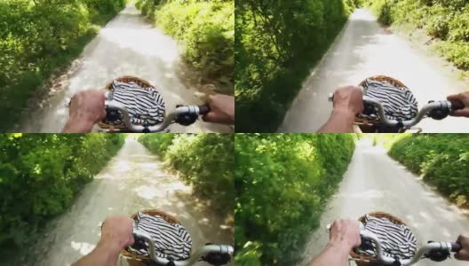 阳光森林里骑折叠自行车的男人高清在线视频素材下载