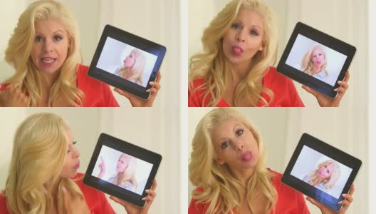 金发美女在平板电脑屏幕上对着自己的视频说话高清在线视频素材下载
