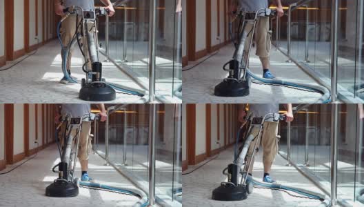 清洁男工人正在清洁酒店走廊的地毯高清在线视频素材下载