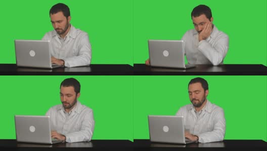 医生在一台笔记本电脑上工作，看起来很累，绿色屏幕，色度键高清在线视频素材下载