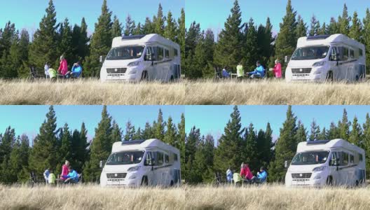 一个有两个孩子的家庭在新西兰露营，并把一辆房车停在他们旁边高清在线视频素材下载