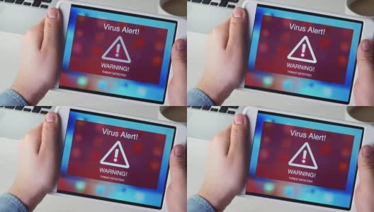 男子手持数字平板电脑，屏幕上有病毒警报警告标志高清在线视频素材下载