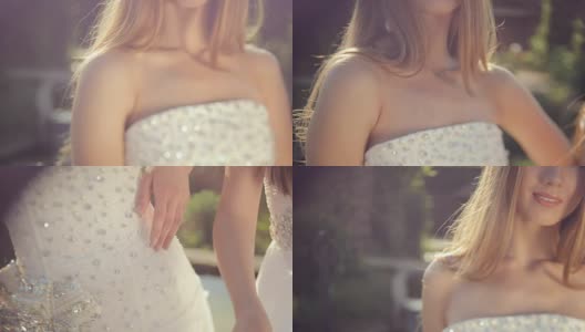秀美少女身穿镶有宝石的白色连衣裙，头戴皇冠，在户外高清在线视频素材下载