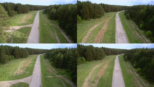 灰色的柏油路被绿色茂密的森林包围着高清在线视频素材下载