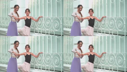 一位亚洲青少年芭蕾舞者在泰国曼谷的一条当地街道上练习芭蕾舞，年轻的女芭蕾舞教师。概念活泼的年轻妇女和孩子在周末的活动。高清在线视频素材下载