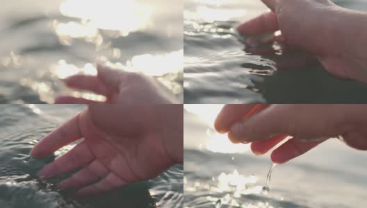 一个女人的手的特写是轻轻触摸海面上的海浪在日落高清在线视频素材下载