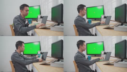 年轻的资讯科技人员使用多台绿屏电脑工作高清在线视频素材下载