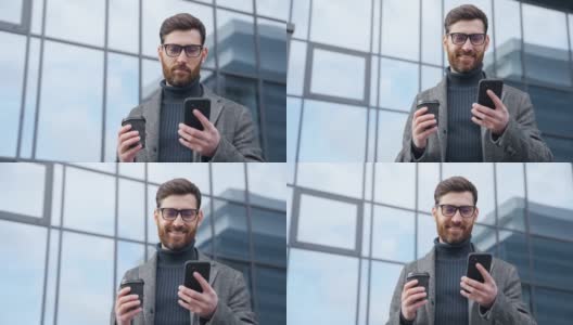 微笑的商人使用智能手机喝咖啡走在办公区高清在线视频素材下载