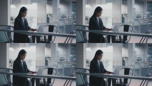 韩国女商人坐在办公中心用笔记本电脑工作高清在线视频素材下载