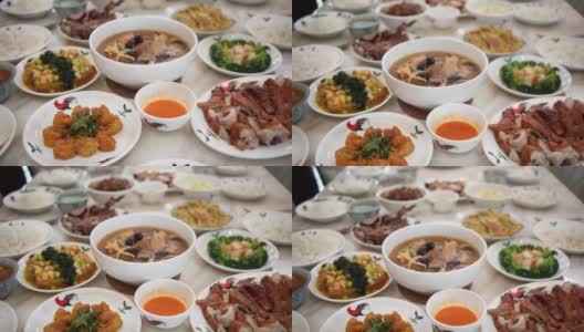 亚洲华人在春节团圆饭期间在餐桌上自制食物高清在线视频素材下载