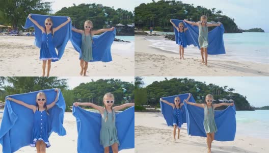 在热带度假期间，小女孩们玩沙滩毛巾玩得很开心高清在线视频素材下载