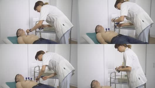 男病人躺在病房附近做心电图高清在线视频素材下载