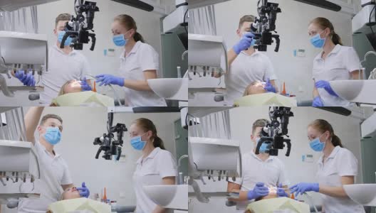 专科医生和助手在牙科室使用光学显微镜对躺着的病人进行口腔手术高清在线视频素材下载