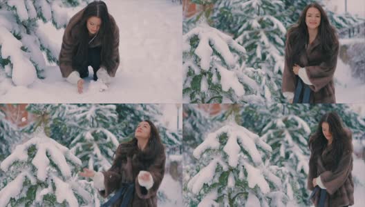 深褐色头发的女人在冬季假期向空中抛雪的慢镜头高清在线视频素材下载