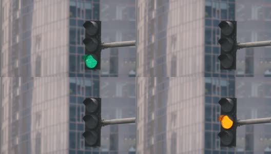 建筑背景上的红绿灯。绿灯亮了，红灯亮了。特写镜头高清在线视频素材下载
