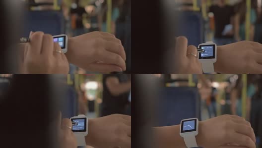 一个女人在公交车上用智能手表高清在线视频素材下载