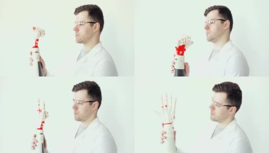 工程师科学家正在专心研究和测试机器人假肢手，它可以用手指进行程序化的运动高清在线视频素材下载