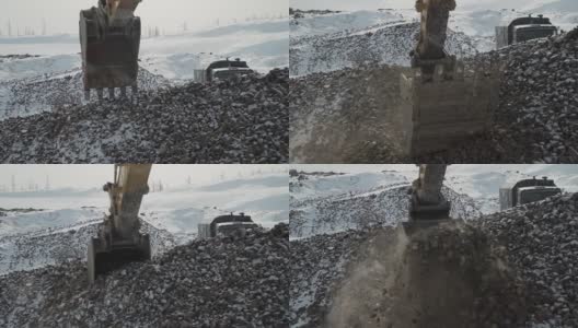 在石油生产的建筑工地，挖掘斗捕捉石头高清在线视频素材下载