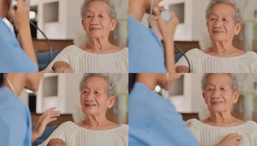 年轻黑人女护士医生为亚洲老年妇女检查心脏，以预防冠状病毒或Covid-19在家里流行。医疗:护理、教育、医疗、护理、志愿者、养老院、冠状病毒或新冠病毒高清在线视频素材下载