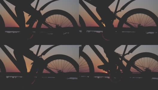 电影复古风格拍摄骑自行车的人骑山地车在傍晚日落的光线在近距离高清在线视频素材下载