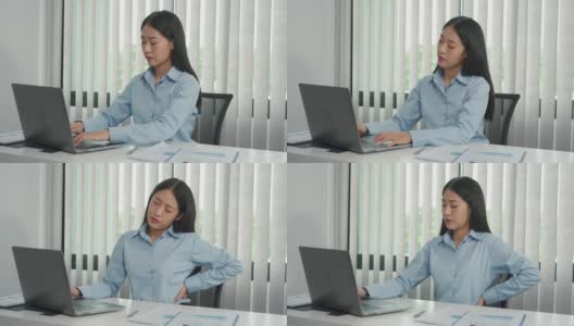 亚洲女性长时间坐着工作，按摩双手时会背痛。高清在线视频素材下载