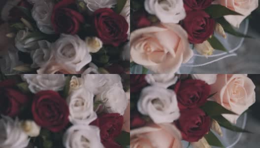 漂亮的白玫瑰和红玫瑰捧成一束。近距离拍摄的花高清在线视频素材下载
