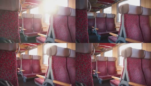 火车车厢里的阳光透过窗户照进来。运输车上的空座位高清在线视频素材下载