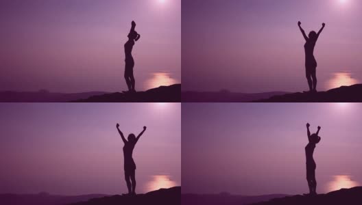 欢呼的女徒步者在日落山顶张开双臂高清在线视频素材下载