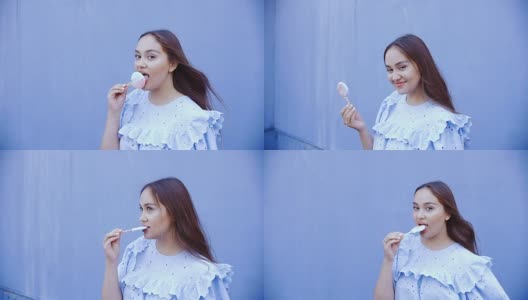 年轻漂亮的长发女子舔着冰淇淋。高清在线视频素材下载