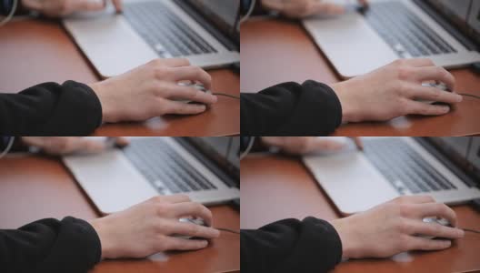 研究生使用笔记本电脑和鼠标在互联网上寻找信息高清在线视频素材下载