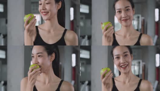 亚洲美女在健身房咬青苹果的肖像。高清在线视频素材下载