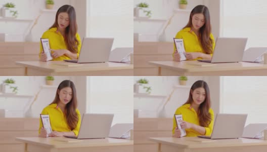 快乐的年轻亚洲女商人戴着黄色和头戴耳机在网上视频电话会议上与她的业务团队展示销售报告，商业启动概念高清在线视频素材下载