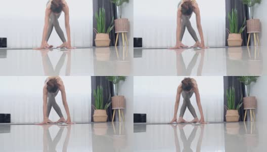 亚洲妇女在运动服做运动训练瑜伽垫在家里。高清在线视频素材下载
