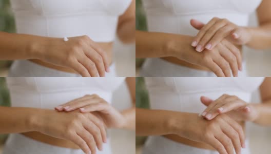 关心的皮肤。近距离拍摄的年轻女子涂抹保湿霜在手掌，呵护她的手高清在线视频素材下载