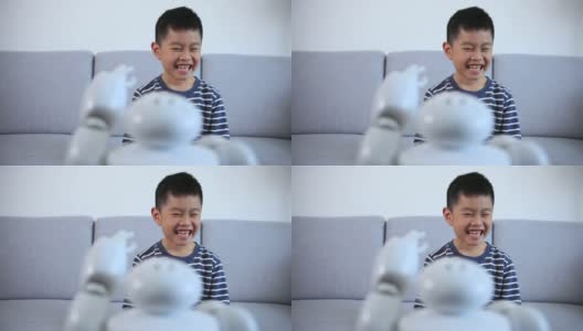 聪明的男孩做个鬼脸，表扬机器人高清在线视频素材下载