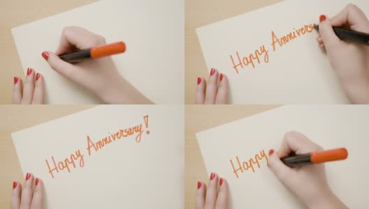 一个有着红色指甲的女学生用红色记号笔在一张空白纸上写着周年快乐高清在线视频素材下载