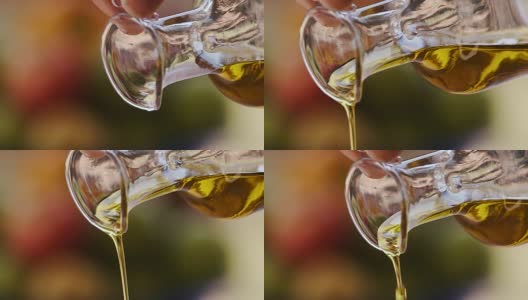 慢镜头特级初榨橄榄油被倒出一个透明的玻璃瓶高清在线视频素材下载