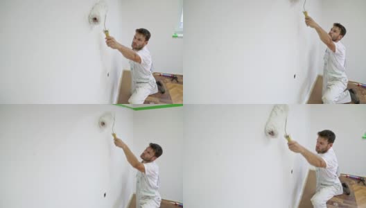 专业油漆工用油漆辊将墙壁刷成白色高清在线视频素材下载