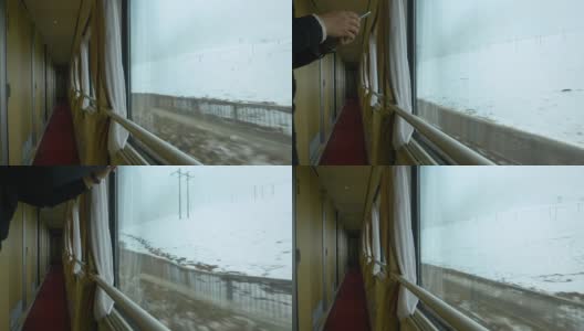 近距离观察:一个不知名的游客在火车上拍摄雪山西藏的照片。高清在线视频素材下载