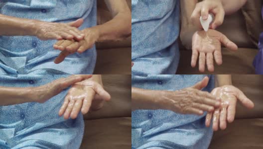 老年妇女使用护工提供的洗手液以帮助预防冠状病毒感染高清在线视频素材下载
