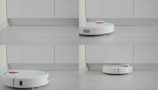 一个机器人真空吸尘器在地板上行驶的特写高清在线视频素材下载