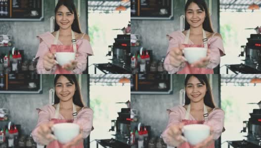 亚洲女咖啡师为顾客提供咖啡。创业的概念高清在线视频素材下载