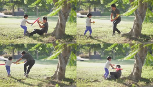 父亲和儿子在公园里打剑，户外。高清在线视频素材下载