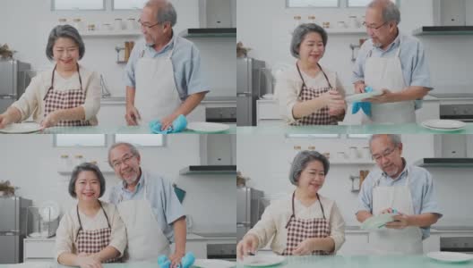 亚洲年轻的家庭主妇捻着湿抹布清洁厨房柜台。为了卫生和健康，老婆婆和男人在家做饭后在桌子和盘子上擦布。高清在线视频素材下载