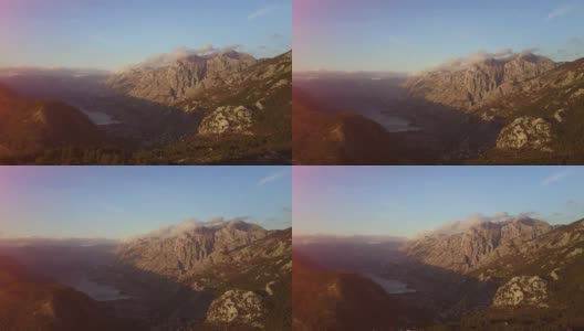 相机在云中移动。梦幻般的日出在岩石山顶上，看到雾气蒙蒙的山谷。高清在线视频素材下载