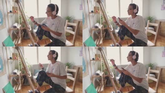 专注的年轻女艺术家利用她的空闲时间，在网上教程的帮助下，创造了一件令人惊叹的艺术作品高清在线视频素材下载
